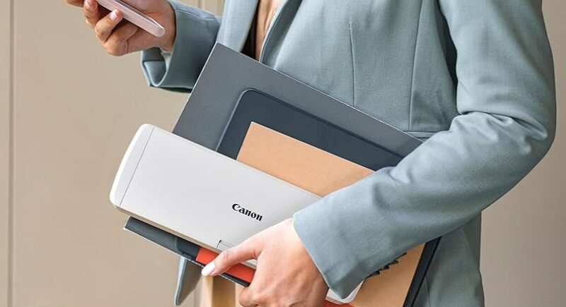 A woman carrying one of the best portable scanners, the Canon Imageformula R10
