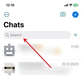 Using the search bar at the top of WhatsApp for iOS to search all chats.