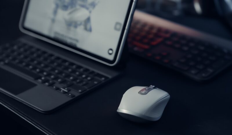 Bluetooth mouse next to a laptop