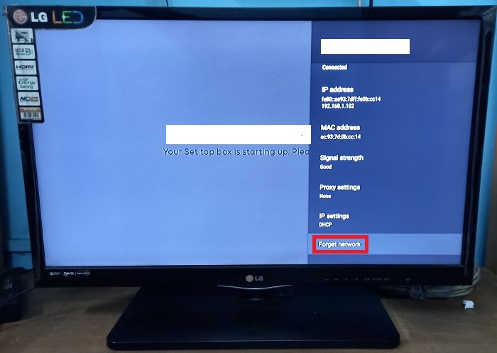 Clicking the "Forget network" option for a Wi-Fi network displayed on a TV. 