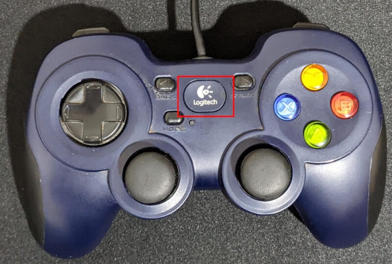 A photograph highlighting the Home button for a basic Logitech controller.