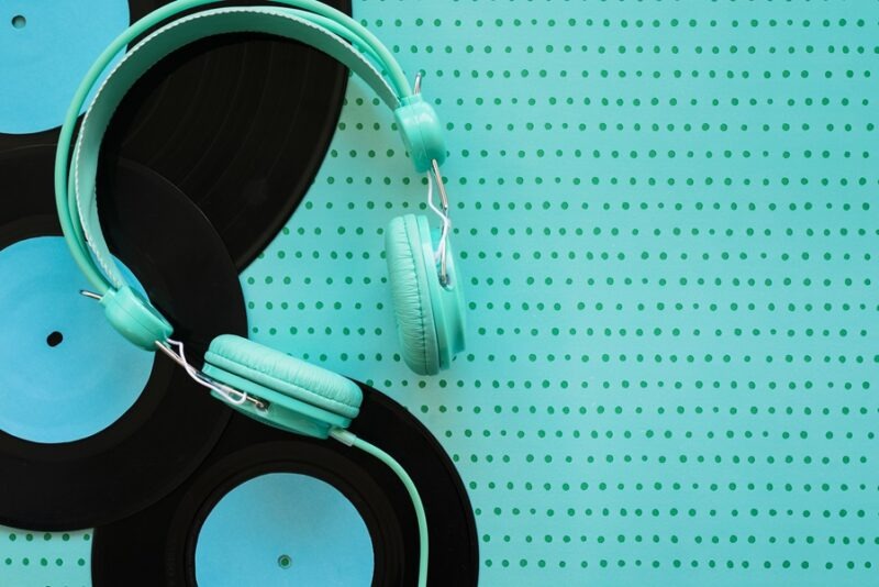 Affordable pair of headphones sitting on blue background.