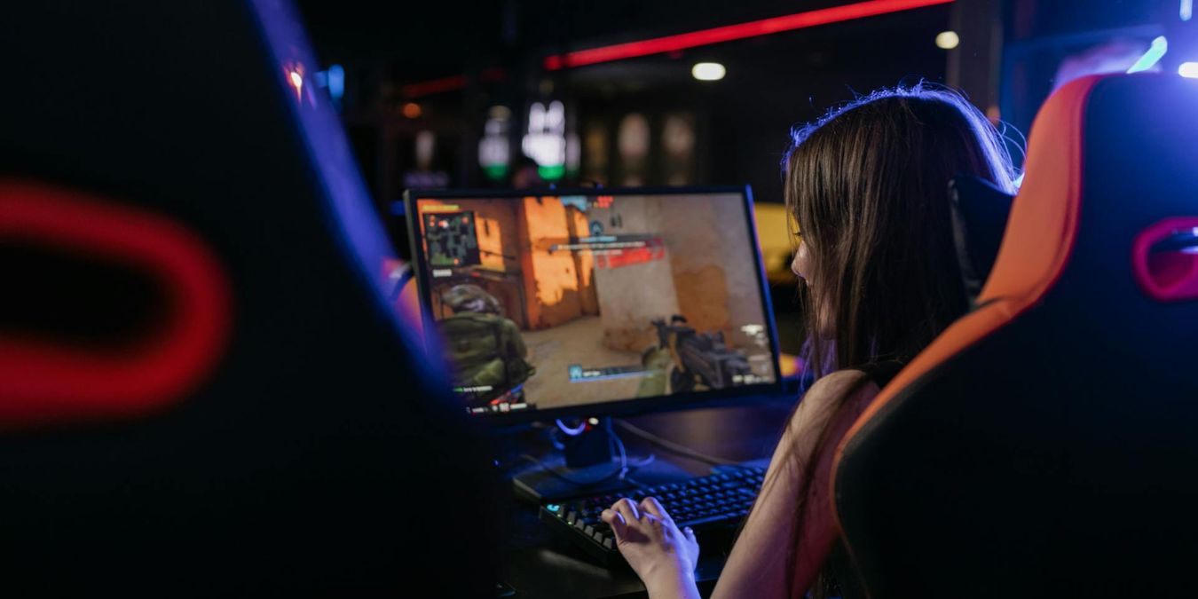 Woman playing a game on a computer.